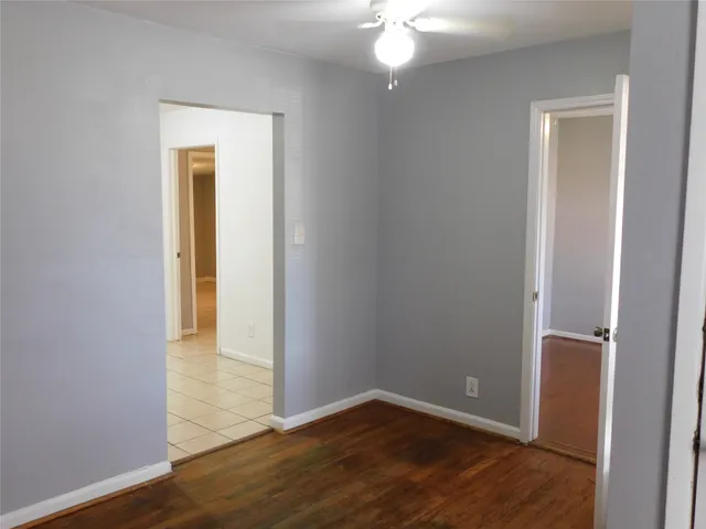 an empty room with wooden floor and closet