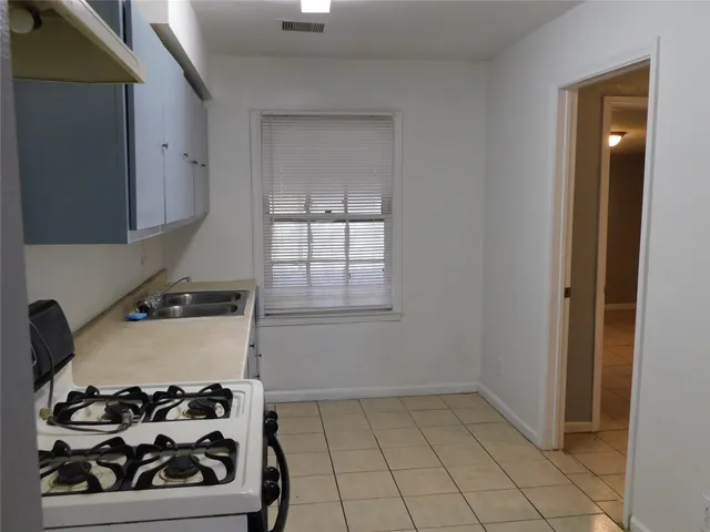 a kitchen with a stove and cabinets