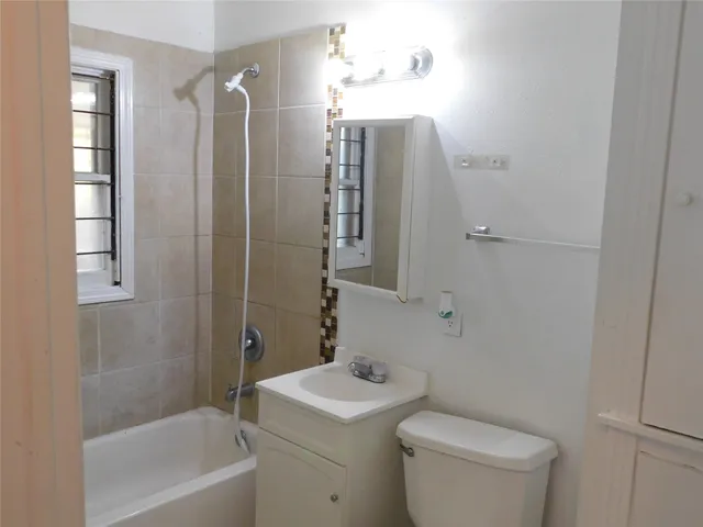 a bathroom with a toilet a sink and shower
