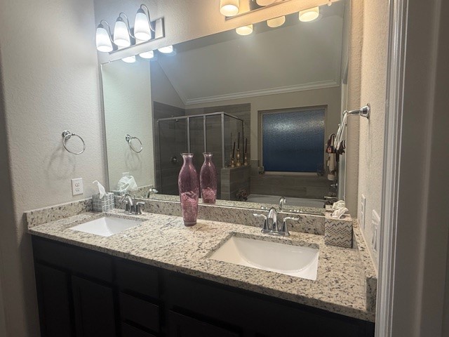 2136 Moss Creek Lane Conroe, TX 77304 - Photo 15 of 23 a bathroom with double vanity sinks a vanity a lamp and a mirror