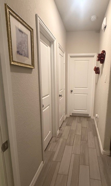 2136 Moss Creek Lane Conroe, TX 77304 - Photo 19 of 23 a view of a room with wooden floor and white doors