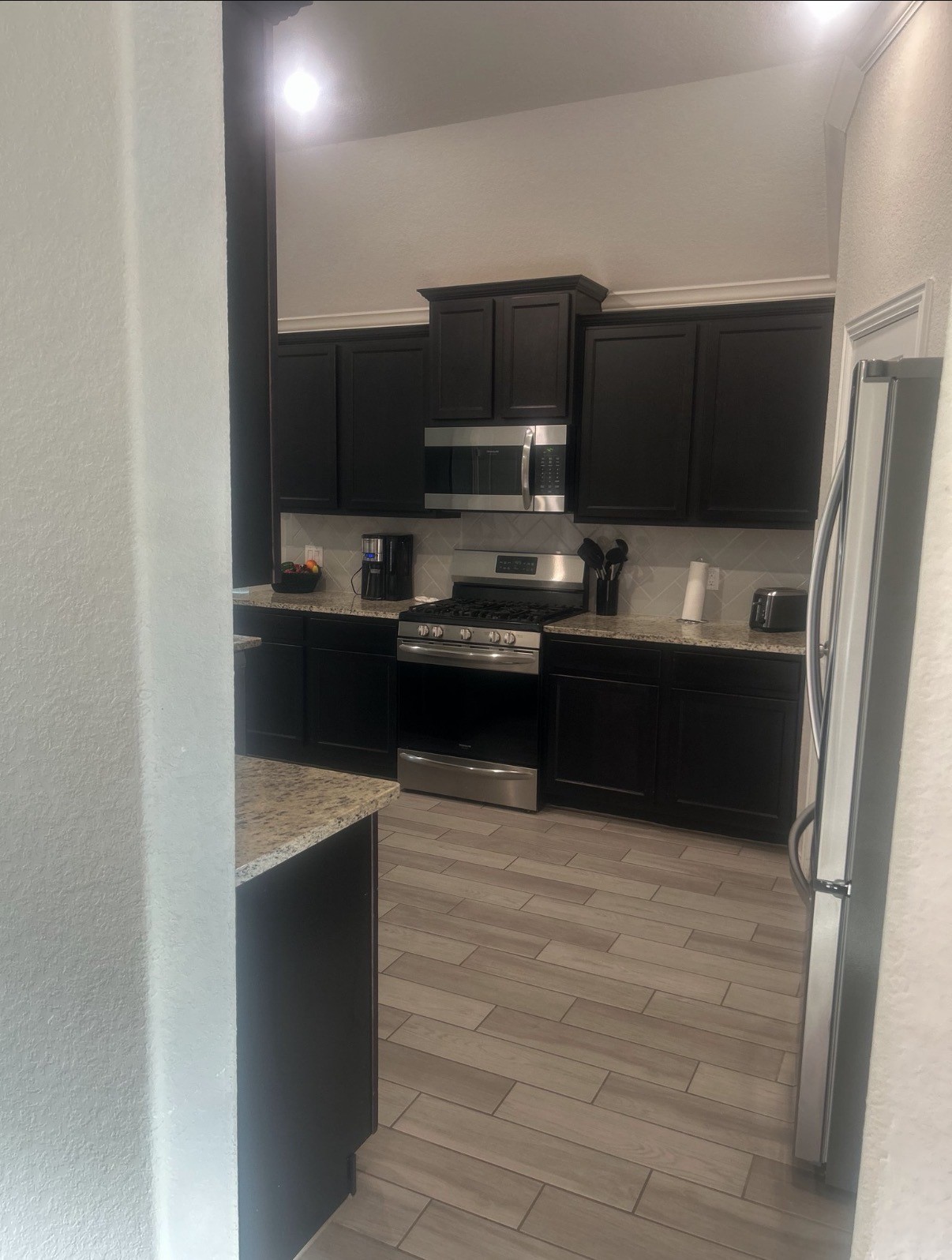 2136 Moss Creek Lane Conroe, TX 77304 - Photo 8 of 23 a kitchen with stainless steel appliances a sink and a refrigerator