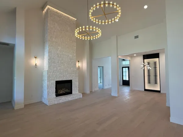 a view of a livingroom with an empty space and a fireplace