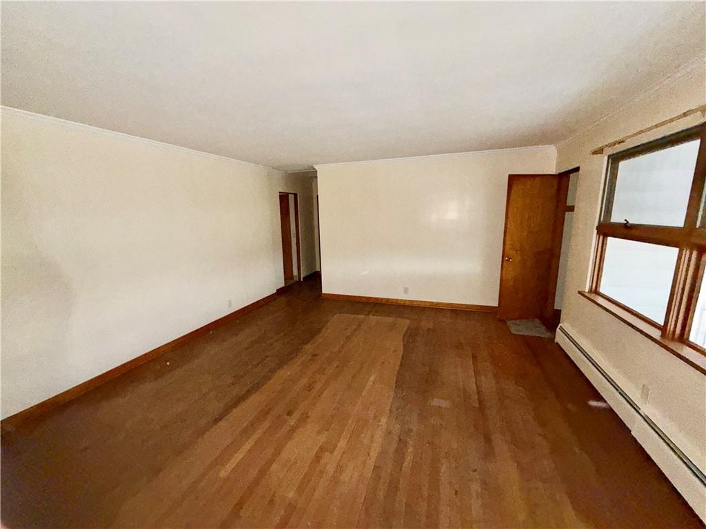 28 Union Street Uniontown, PA 15401 - Photo 3 of 9 an empty room with wooden floor and windows