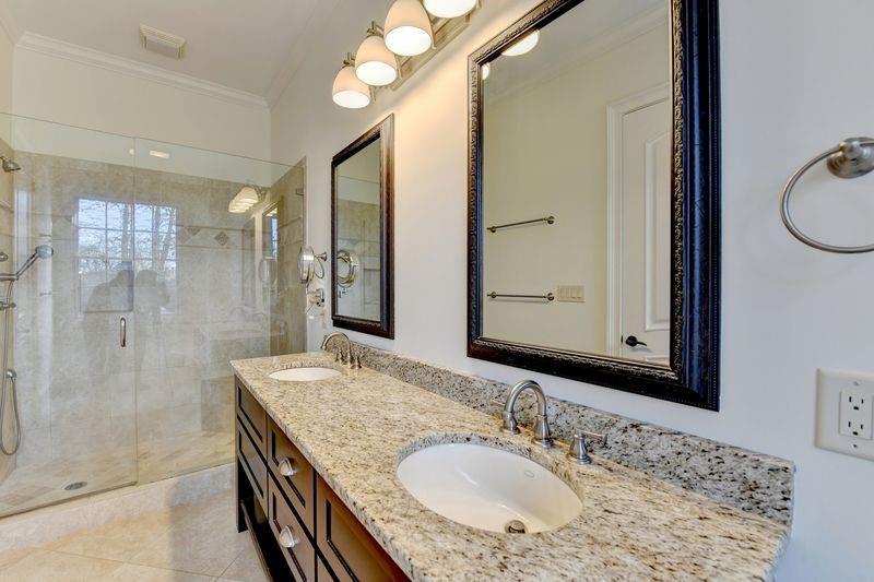 4045 Ridge Road Buford, GA 30519 - Photo 33 of 97 a bathroom with a granite countertop sink a mirror and a shower