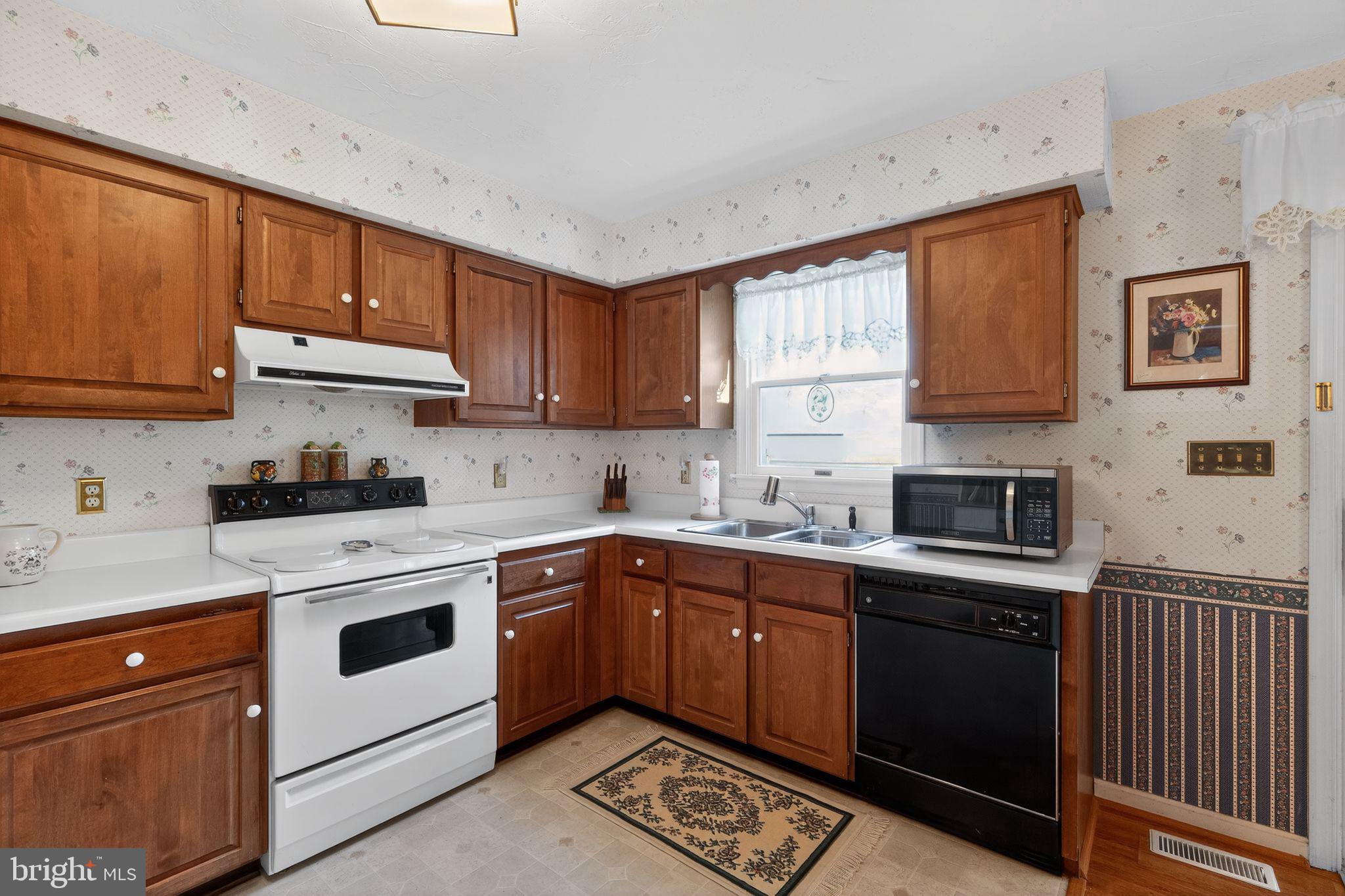 23 Crescent Lane Littlestown, PA 17340 - Photo 14 of 30 a kitchen with stainless steel appliances granite countertop a stove sink and cabinets