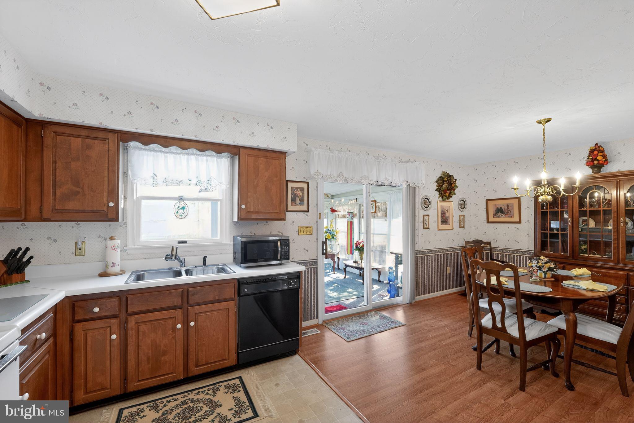 23 Crescent Lane Littlestown, PA 17340 - Photo 15 of 30 a kitchen with stainless steel appliances kitchen island granite countertop wooden floors and white cabinets