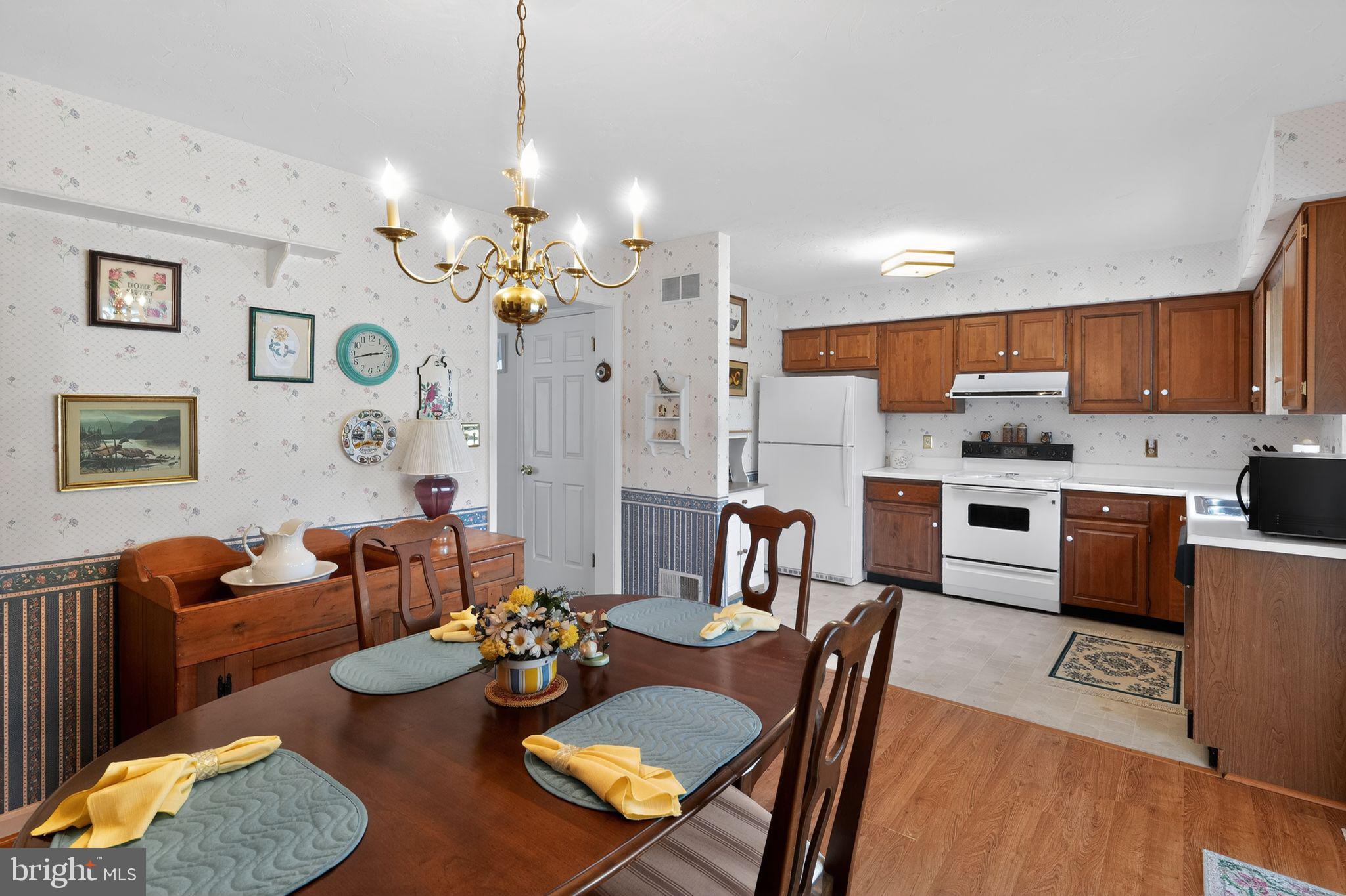 23 Crescent Lane Littlestown, PA 17340 - Photo 19 of 30 a open dining room with furniture kitchen view and a chandelier