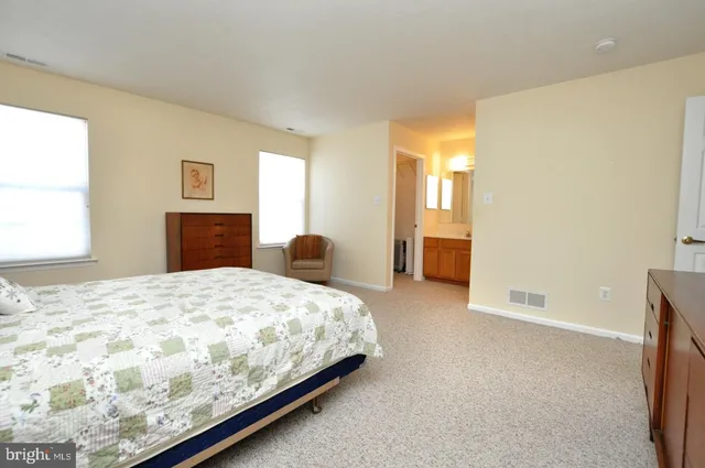 a bedroom with a bed and a couch