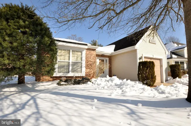 a view of a house with snow in front of it