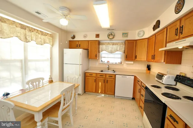 a kitchen with a sink stove and refrigerator