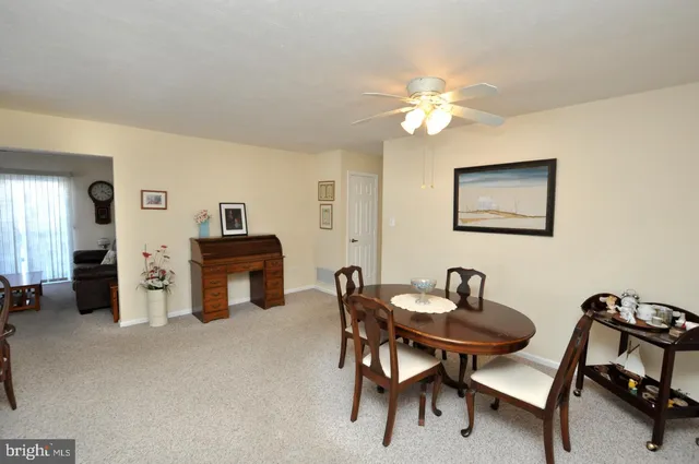 a dining room with furniture and a chandelier