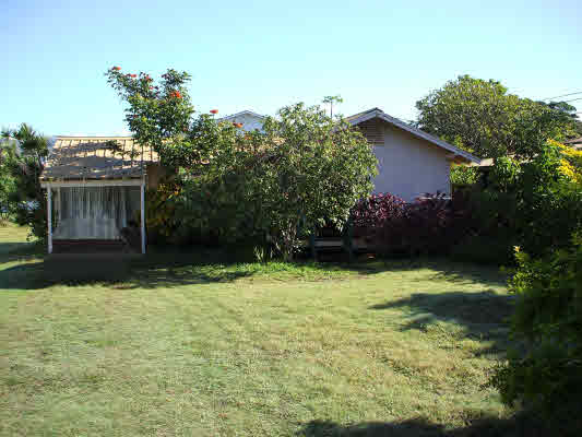 8645 Elepaio Road Kekaha, HI 96752 - Photo 1 of 1 a backyard of a house with lots of green space