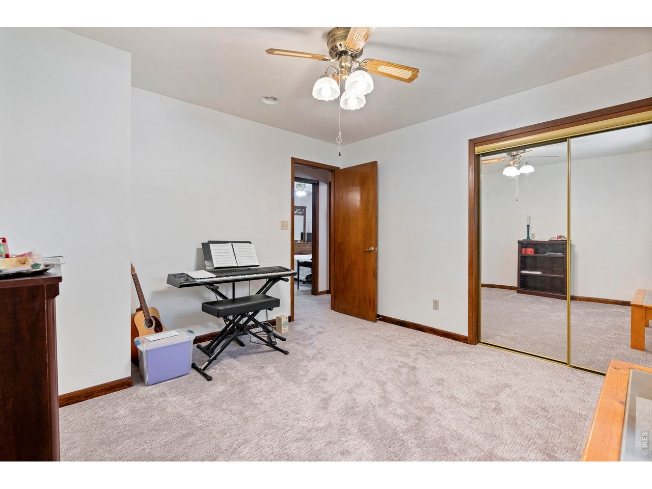 300 Ranch Acres Drive Loveland, CO 80538 - Photo 19 of 38 a workspace with chandelier fan and wooden floor