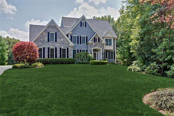 a front view of a house with a garden