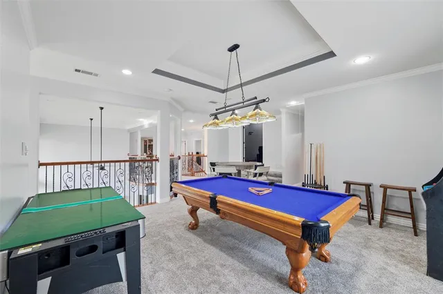 a room with pool table and windows