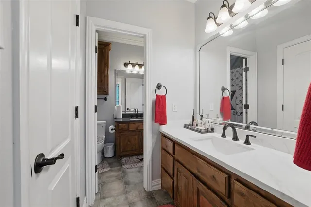 a bathroom with a sink vanity and a mirror
