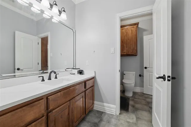 a bathroom with a sink a toilet and a mirror