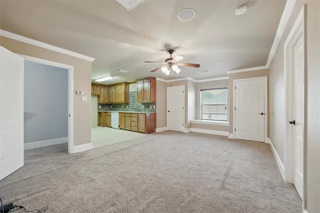 an empty room with chandelier and windows
