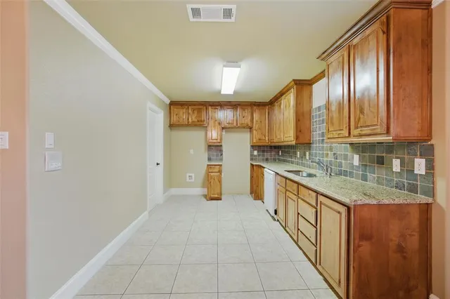 a large kitchen with stainless steel appliances granite countertop a refrigerator and a stove top oven