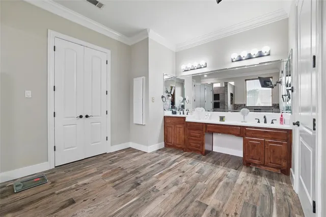 a large bathroom with a large mirror vanity and shower