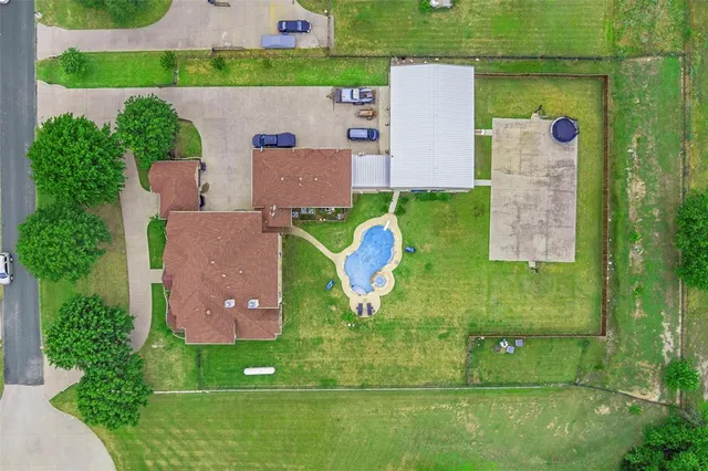 a view of a house with swimming pool and yard with green space