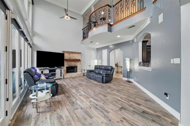 a living room with furniture a flat screen tv and a fireplace