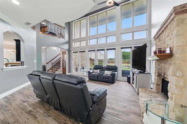 a living room with furniture a fireplace and a flat screen tv
