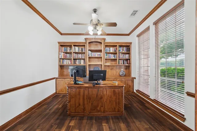 a view of a room with workspace and wooden floor