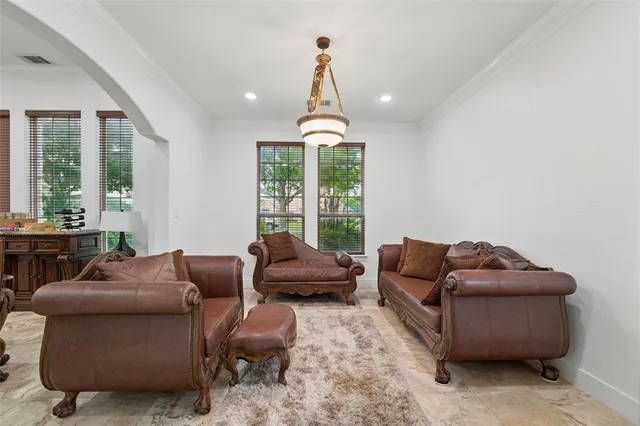 a living room with furniture ceiling fan and a window