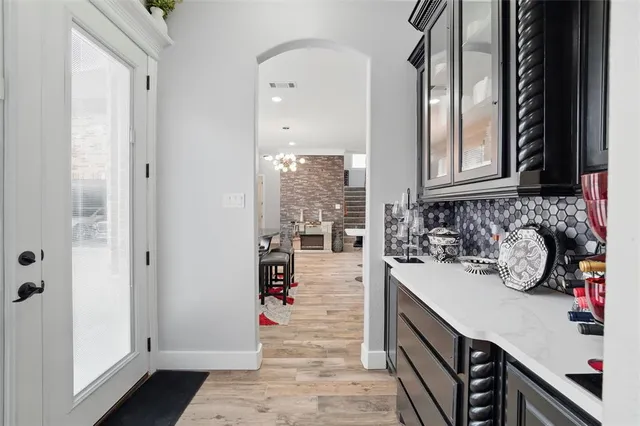 a kitchen with a sink a stove and cabinets