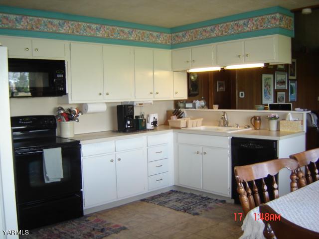 5711 Lateral A Road Wapato, WA 98951 - Photo 7 of 16 a kitchen with a sink cabinets and wooden floor