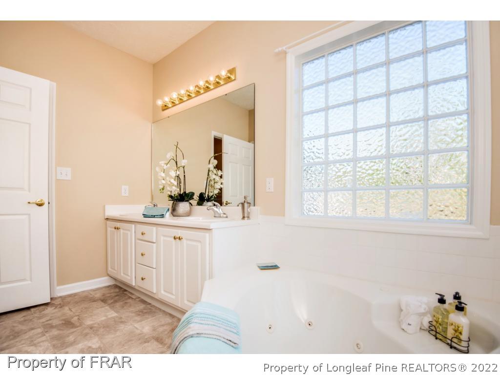 3050 McDuffies Mill Road, Unit 7 Fayetteville, NC 28311 - Photo 13 of 22 a bathroom with a sink and a mirror