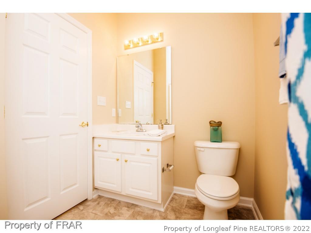 3050 McDuffies Mill Road, Unit 7 Fayetteville, NC 28311 - Photo 15 of 22 a bathroom with a toilet a sink and a mirror