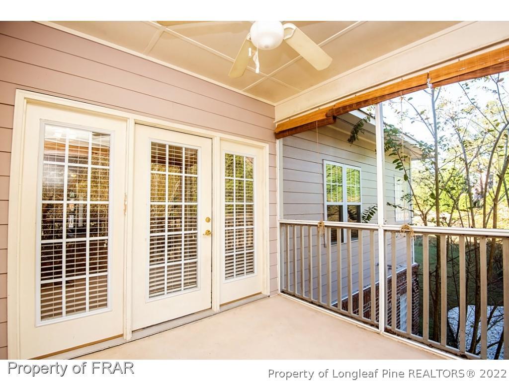 3050 McDuffies Mill Road, Unit 7 Fayetteville, NC 28311 - Photo 17 of 22 a view of a balcony with a floor to ceiling window and wooden fence