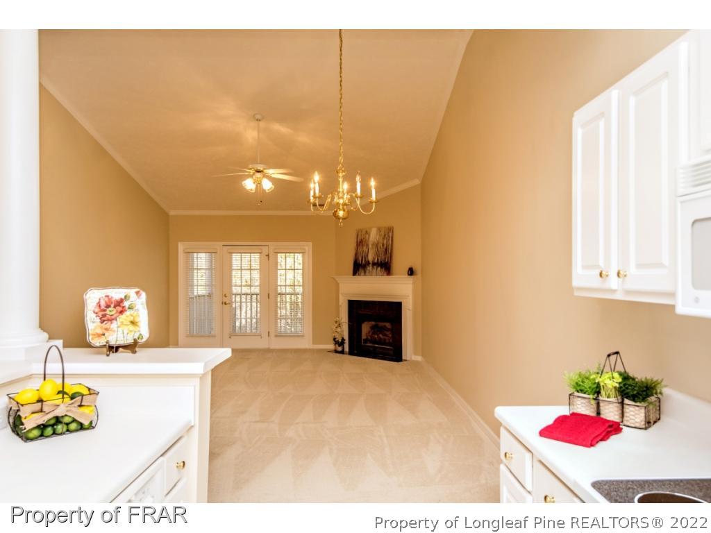 3050 McDuffies Mill Road, Unit 7 Fayetteville, NC 28311 - Photo 9 of 22 a bedroom with a bed and a chandelier