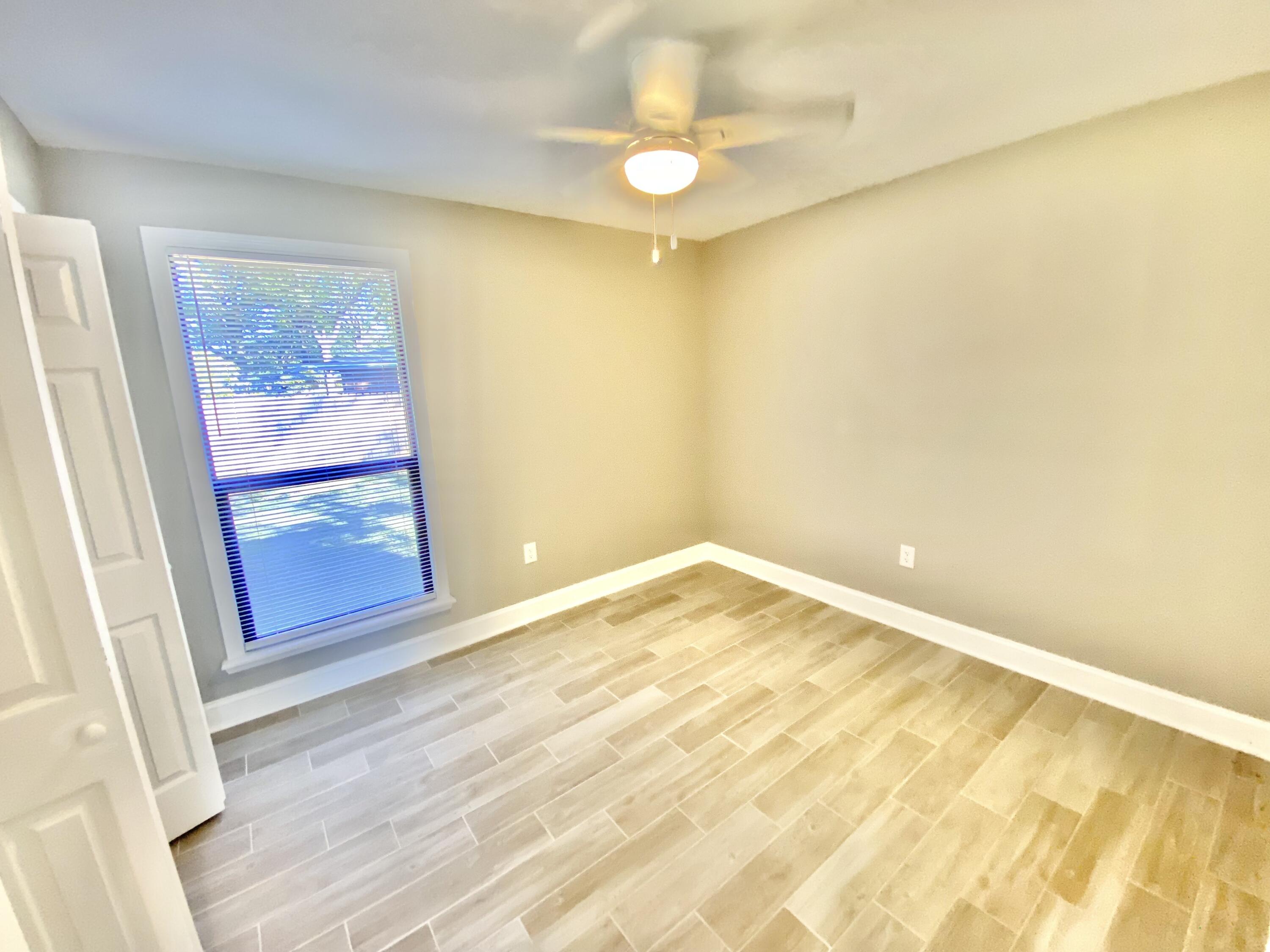 795 Bay Street Crestview, FL 32536 - Photo 14 of 34 a view of empty room with wooden floor