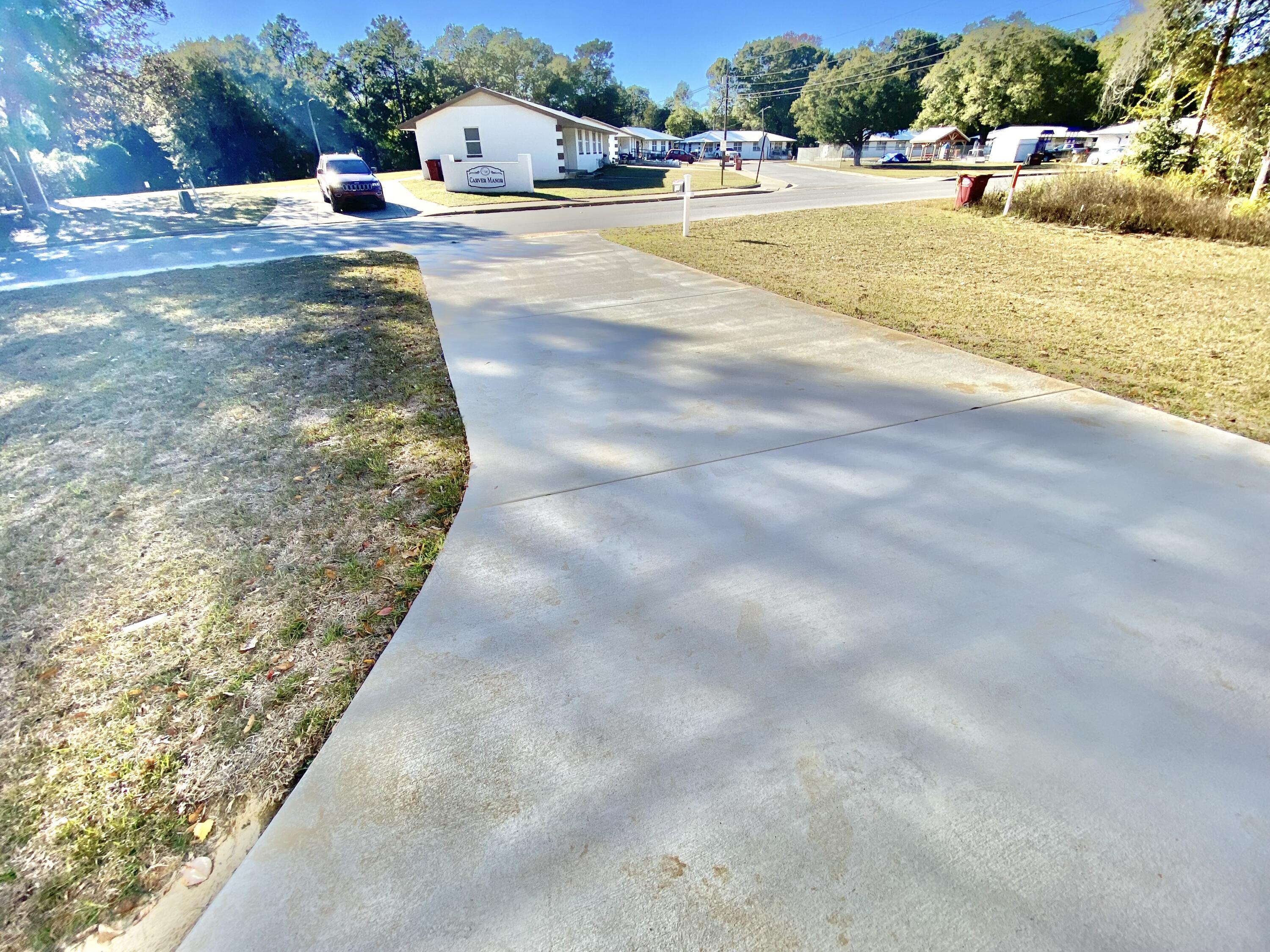 795 Bay Street Crestview, FL 32536 - Photo 4 of 34 a swimming pool with plants and large trees