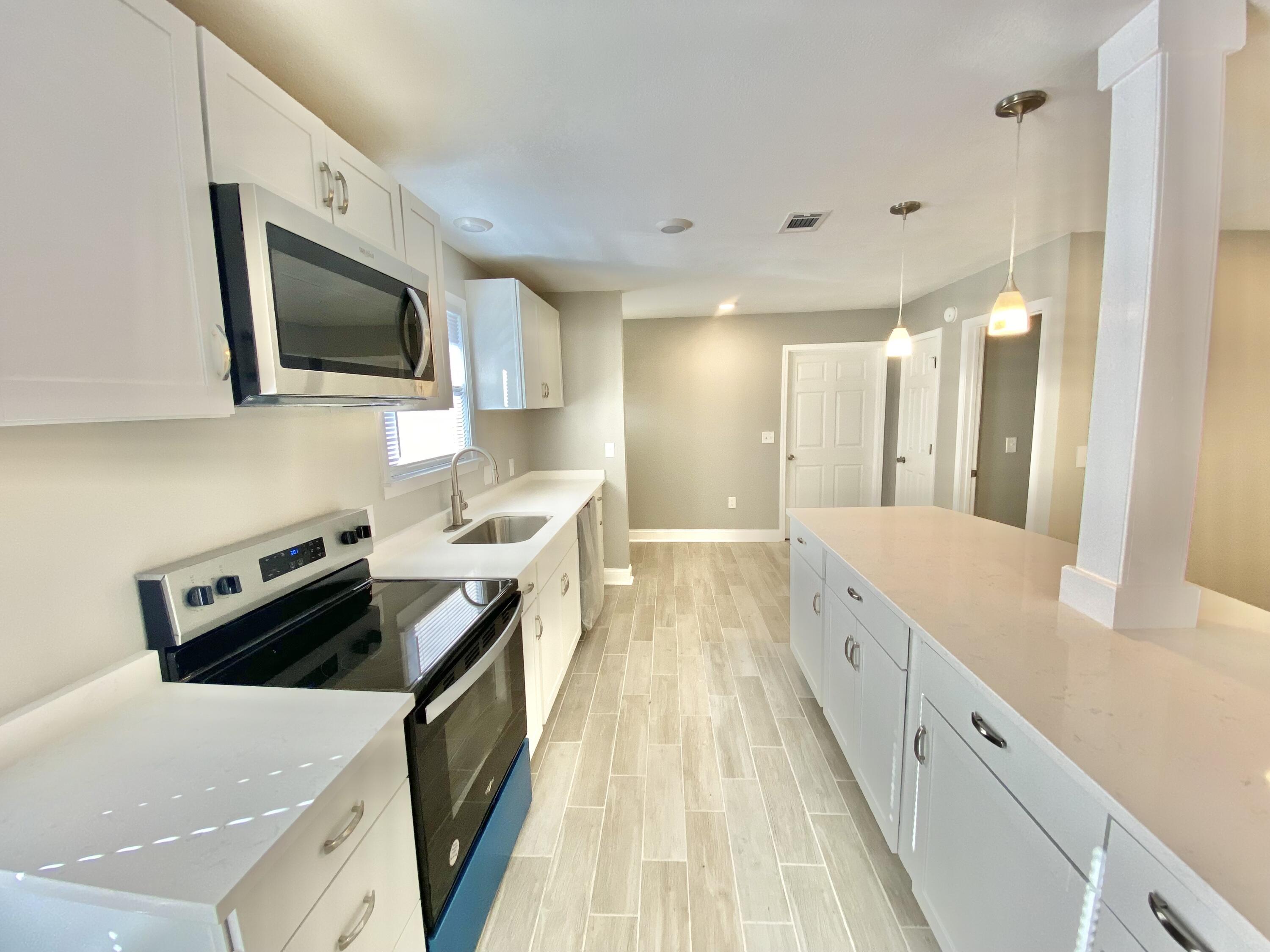 795 Bay Street Crestview, FL 32536 - Photo 10 of 34 a kitchen with a stove and a sink