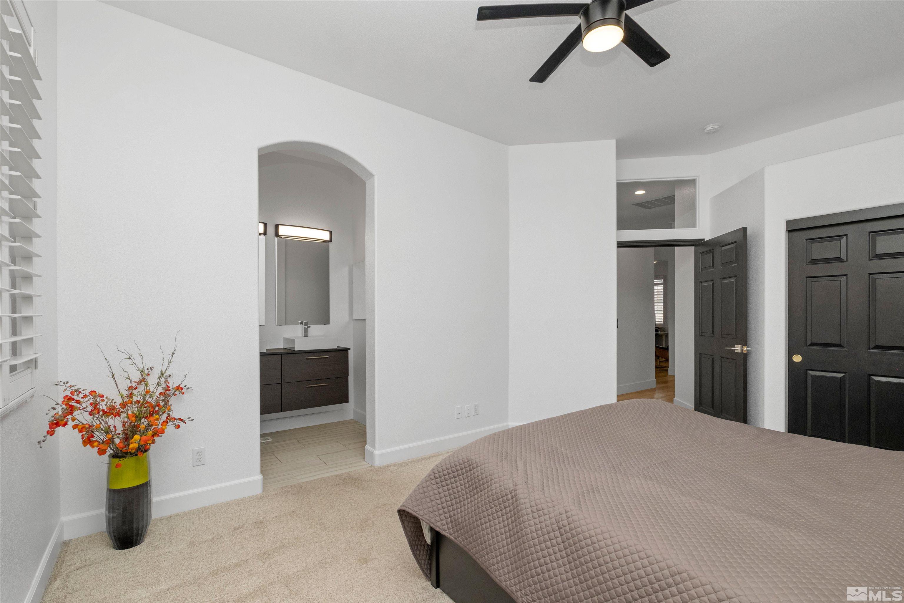 1651 Box Canyon Drive Reno, NV 89521 - Photo 13 of 40 a bedroom with a bed and ceiling fan