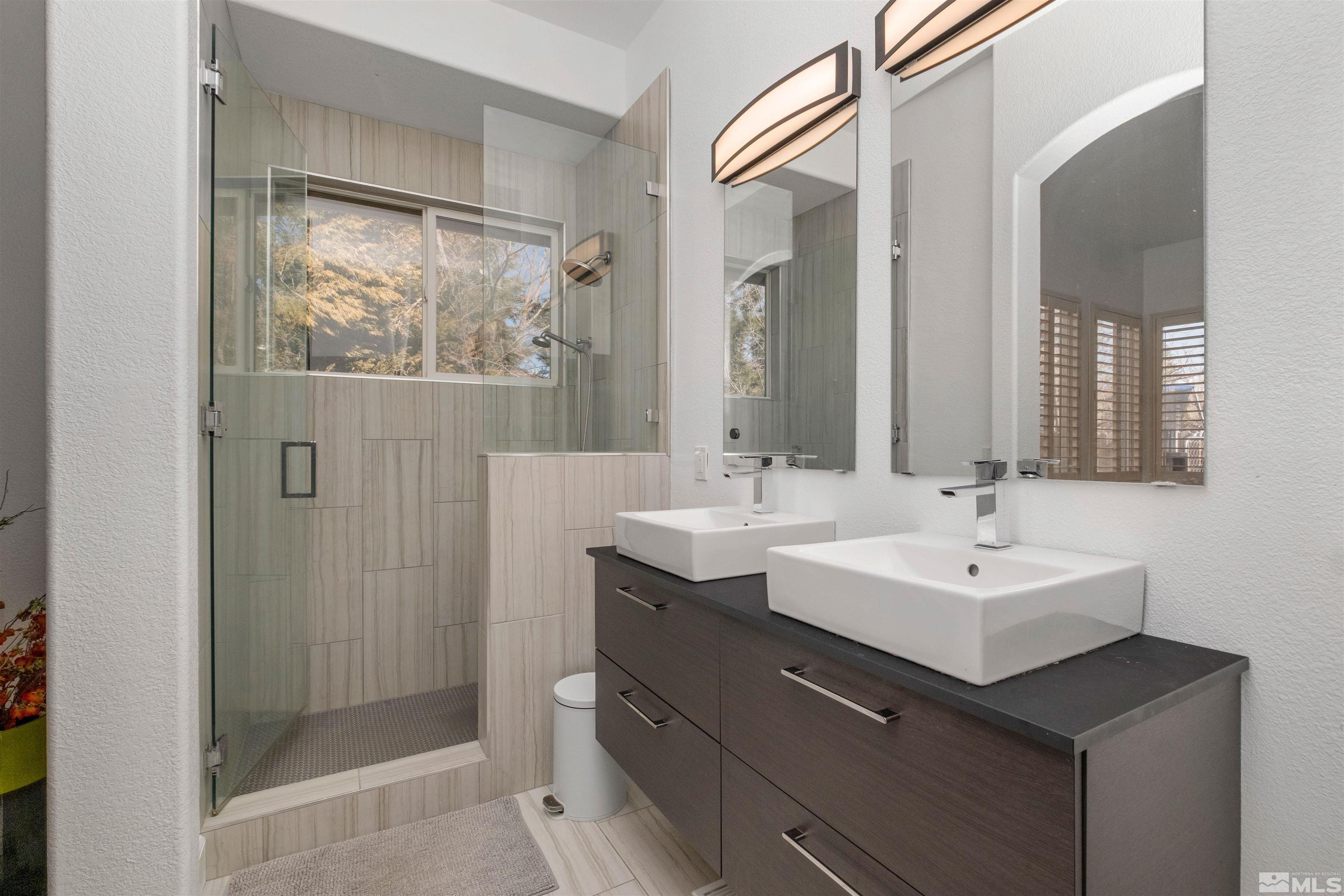 1651 Box Canyon Drive Reno, NV 89521 - Photo 14 of 40 a bathroom with a double vanity sink mirror and shower