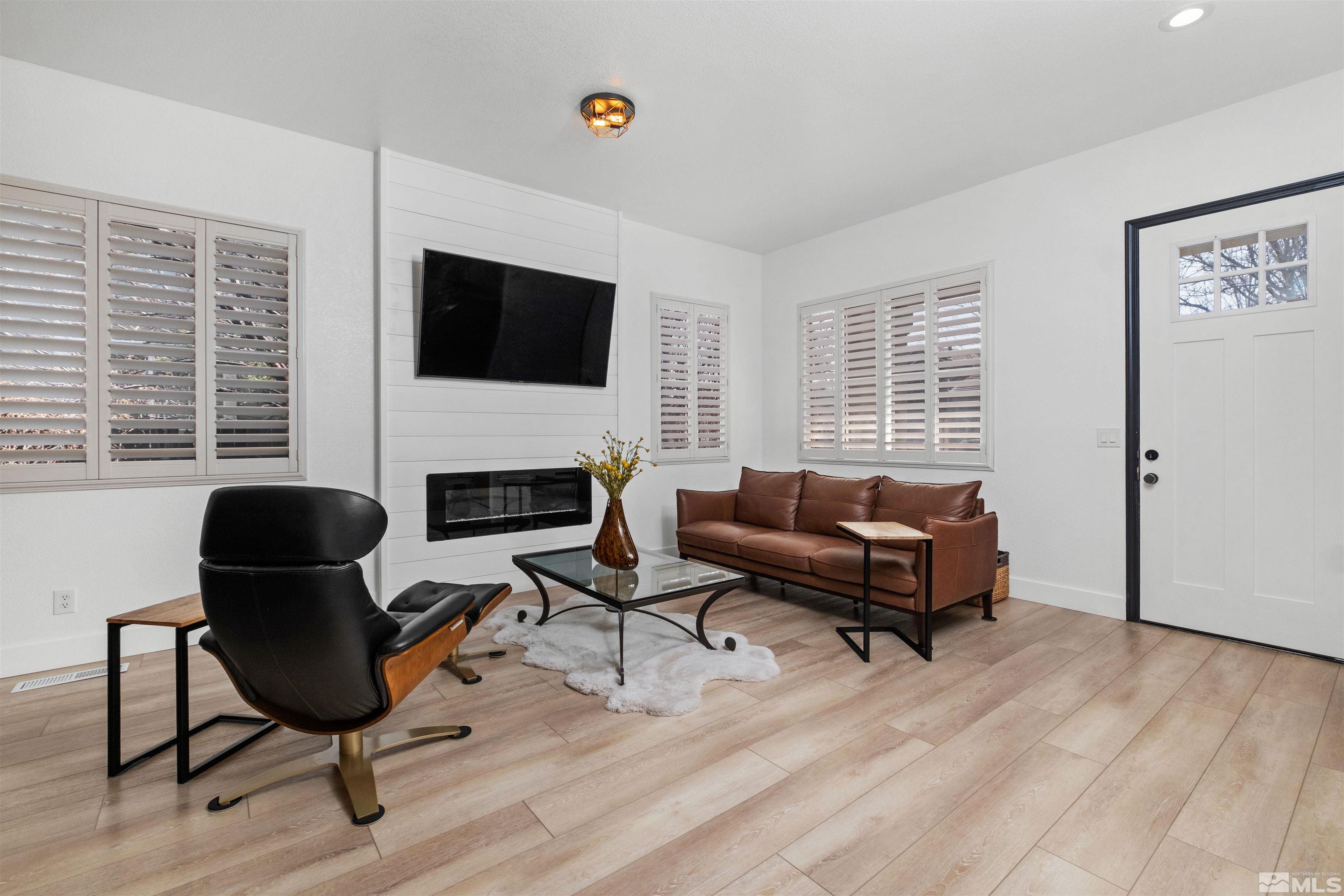 1651 Box Canyon Drive Reno, NV 89521 - Photo 5 of 40 a living room with furniture a flat screen tv and a fireplace