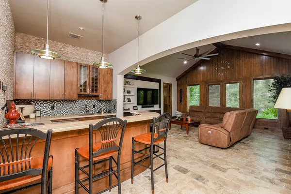 a kitchen with granite countertop a sink dishwasher stove and cabinets