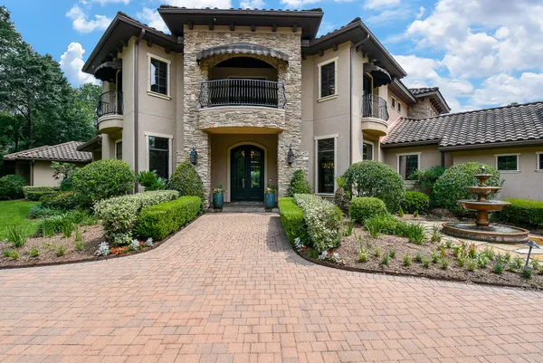 a front view of a house with garden