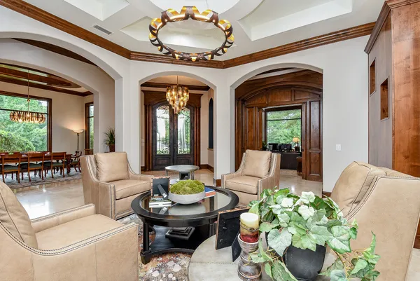a view of a dining room with furniture wooden floor and a chandelier
