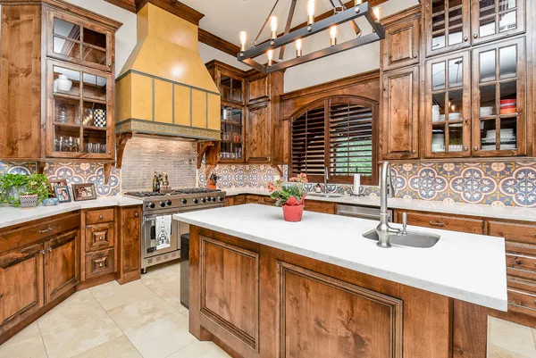 a kitchen with stainless steel appliances granite countertop a stove and a refrigerator