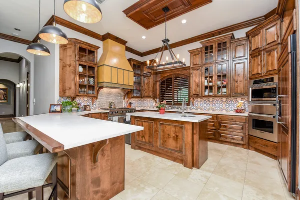 a kitchen with stainless steel appliances granite countertop a stove and a refrigerator