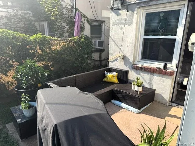 a view of balcony with two chairs and a potted plant
