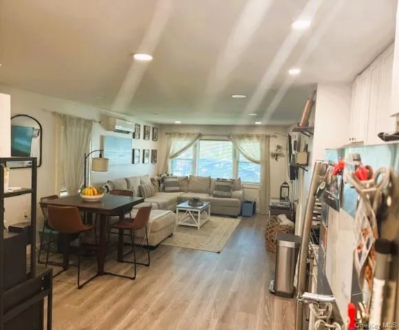 a living room with lots of furniture and a wooden floor
