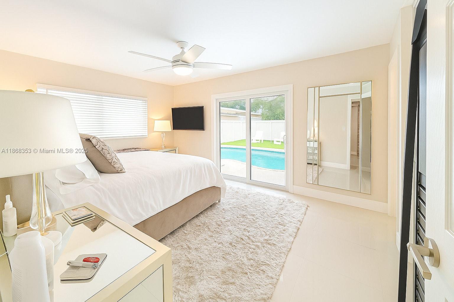 5250 Southwest 96th Avenue Miami, FL 33165 - Photo 11 of 16 a bedroom with a bed and a large window